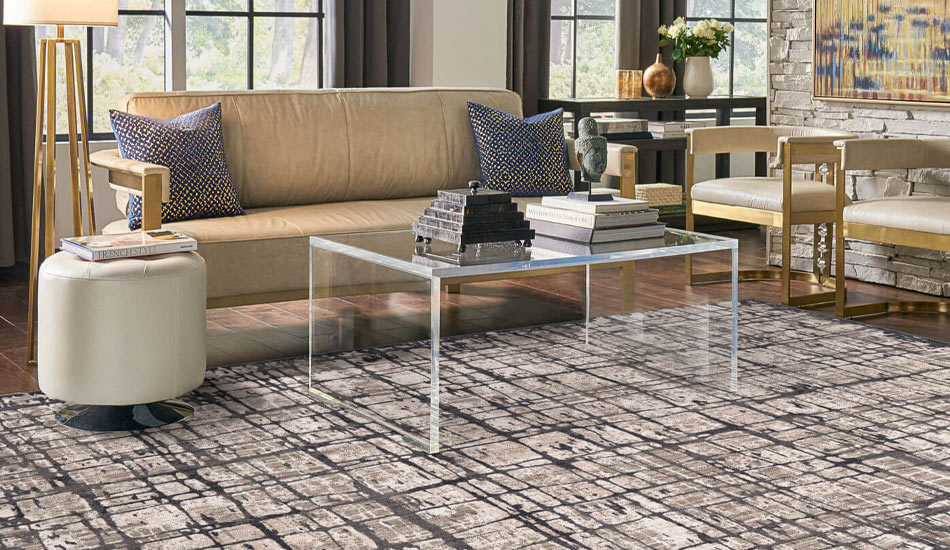 Patterned gray area rug in modern stylish living room with leather couch