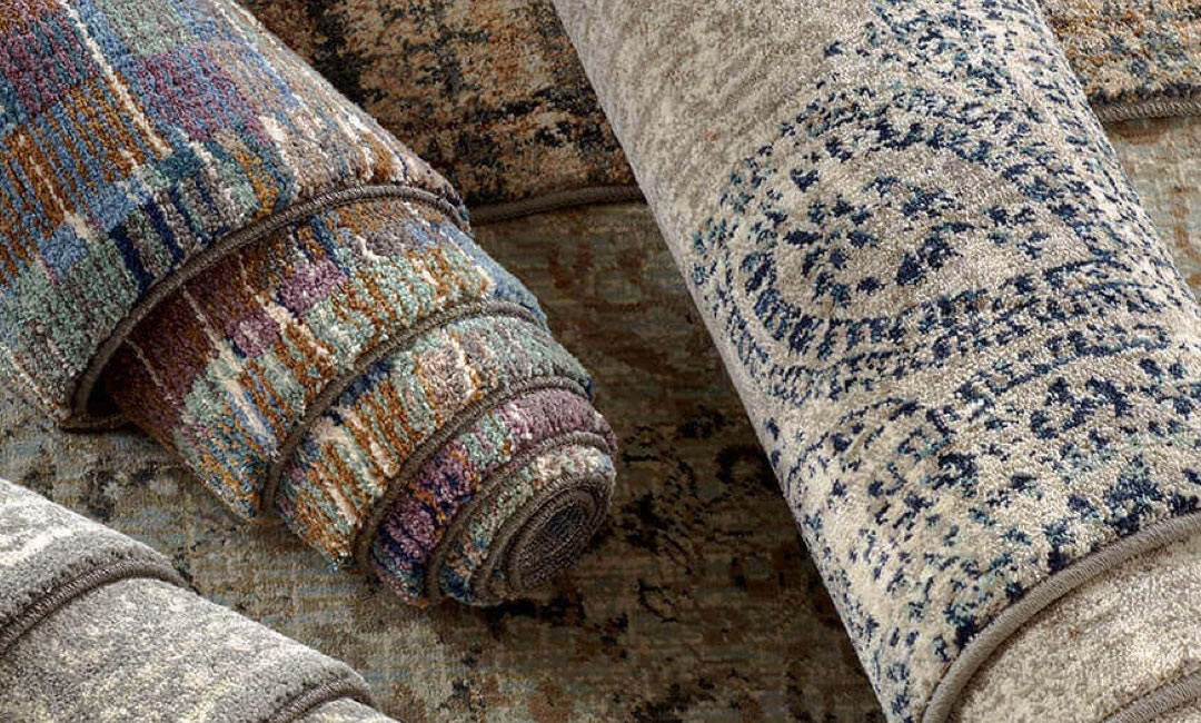 Pile of high-end area rugs with mutiple colors and styles
