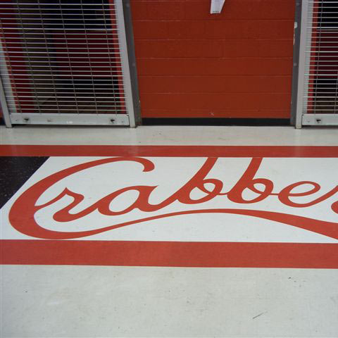 High school commercial floor with red and black Crabbers design